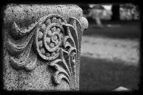 Black and white image of a headstone symbolizing how your family’s lifestyle may change if you pass away without life insurance coverage