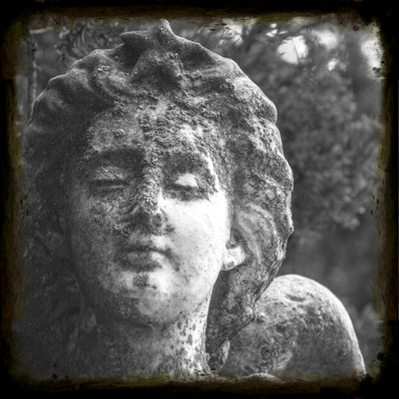 Black and white photo of an old angel statue symbolizing loss and grief, representing the emotional impact of dying without life insurance.