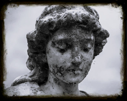 Weathered cemetery statue covered in moss, symbolizing loss and the emotional weight families face when forced to crowdfund funeral expenses due to lack of life insurance