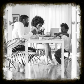 Happy young family eating breakfast together at home, representing stability, love, and the importance of affordable life insurance protection.