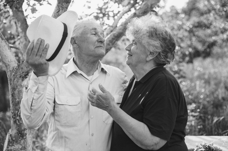 Black and white photo of a joyful senior couple enjoying time together, symbolizing peace of mind and dignity provided by final expense insurance.