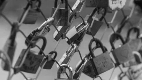 Locks on a fence, symbolizing locking in life insurance rates for young and healthy adults