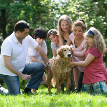 Family enjoying time together outdoors, representing the long-term security of whole life insurance.