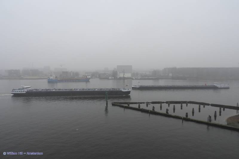 she is small behind two passing inlandtankers