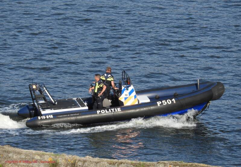 in a tight uniform in a rubberboat with another man in Amsterdam and standing like this... yes you can almost feel  the pride
