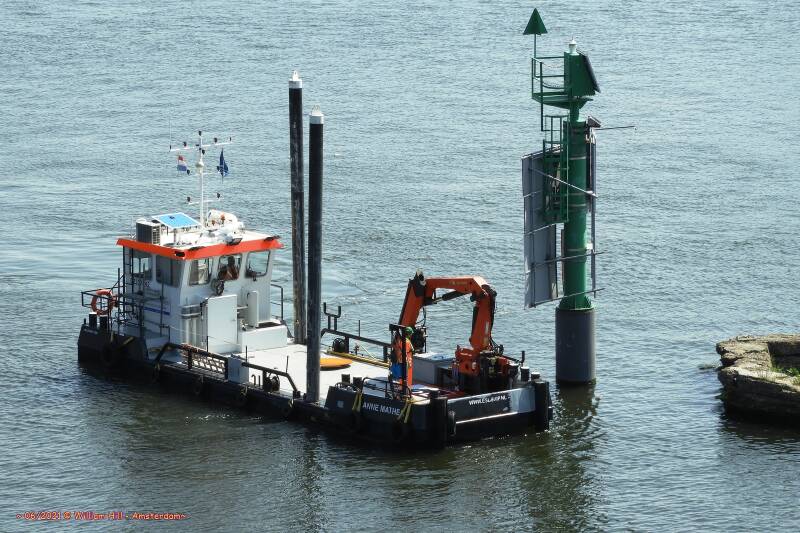 workship ANNE MATHEA comes to hang some extra sign on the signal pole