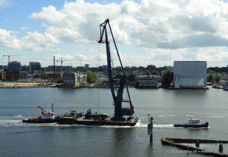 10:48, tugs WATERMAN and DANCING WATER with huge crane underway to the shipyard