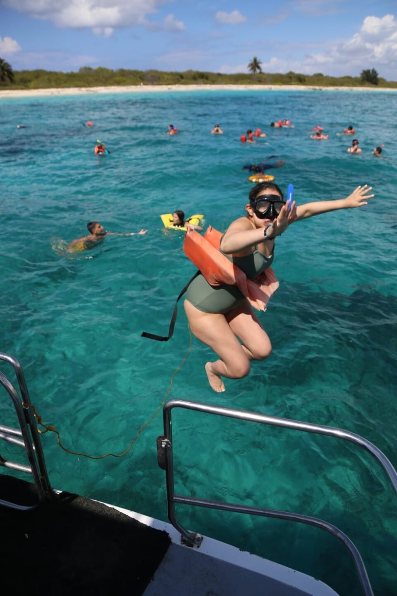 Guest entering the Caribbean water for snorkeling at Catalina Island