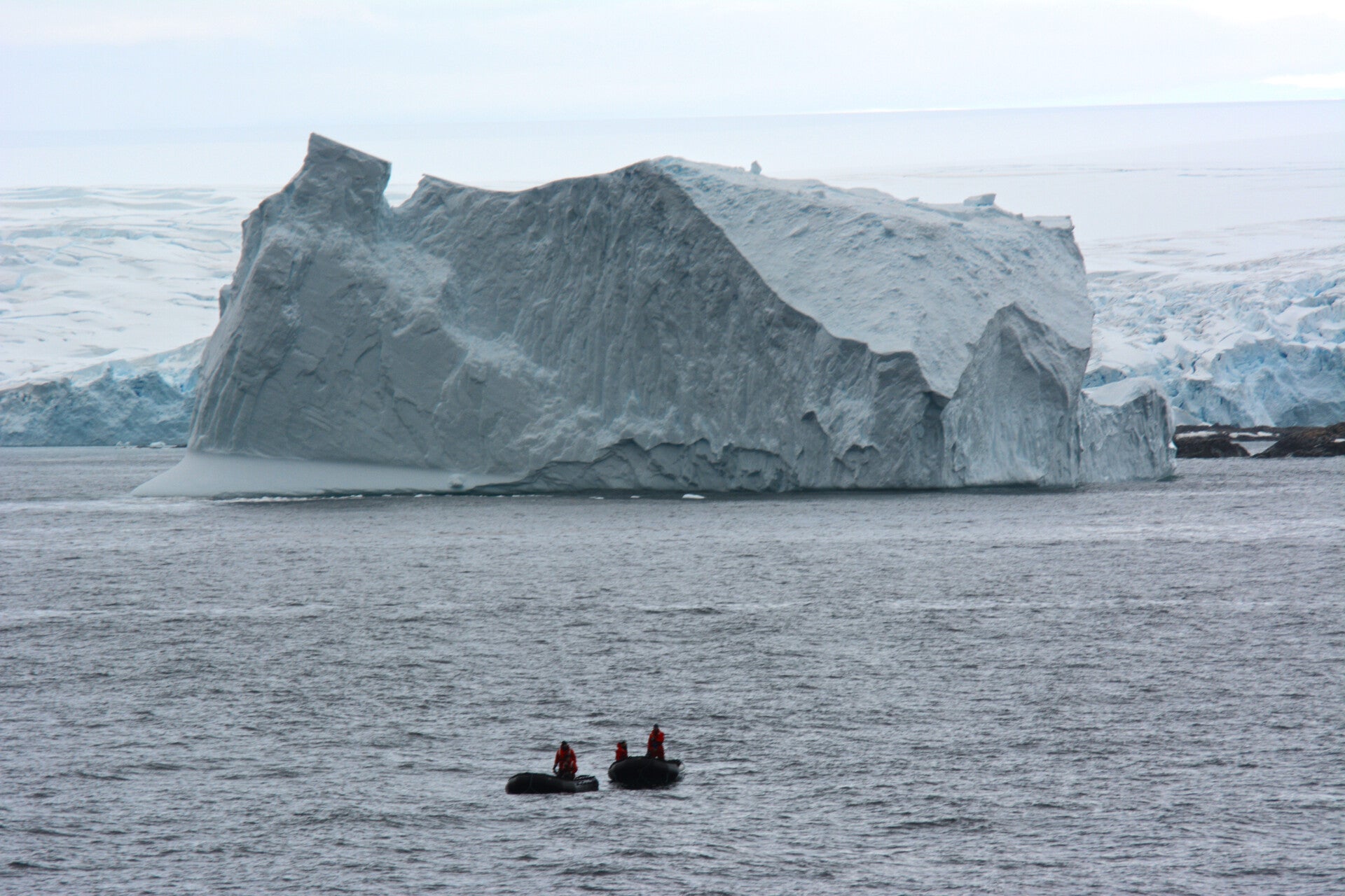 giant iceburg with zodiak antarctica