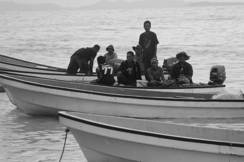 locals on boat chuuk micronesia