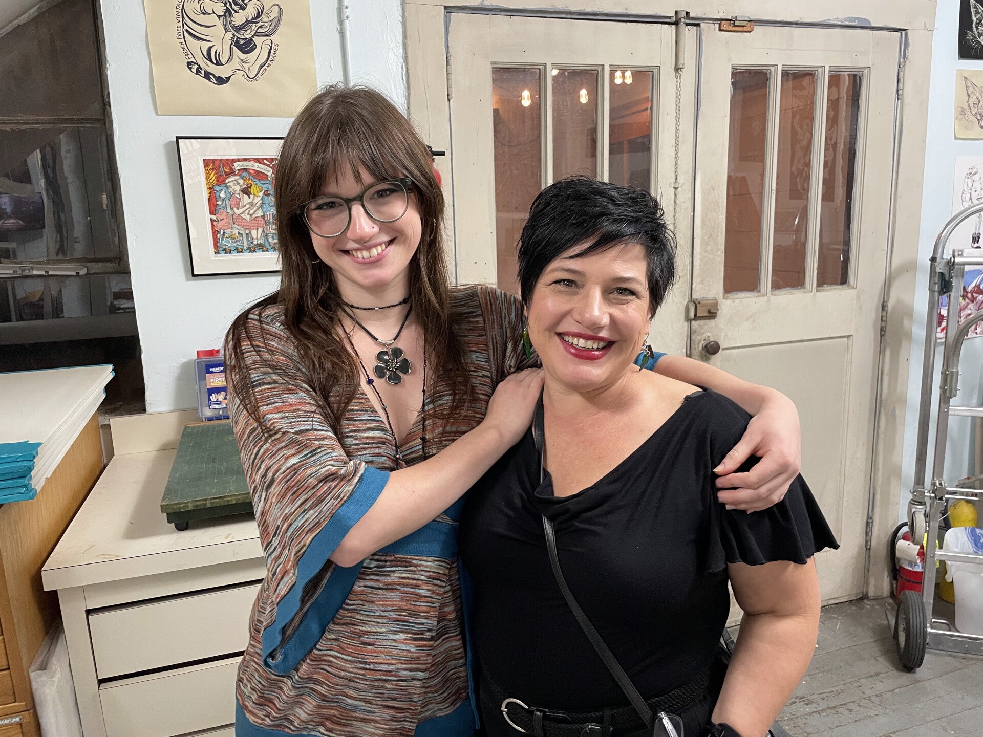 Laurie standing with her daughter Gabi, smiling together indoors.