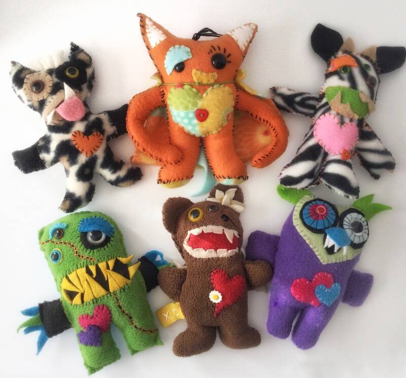 Examples of colorful handmade monsters made from It’s Sew Easy Kits.