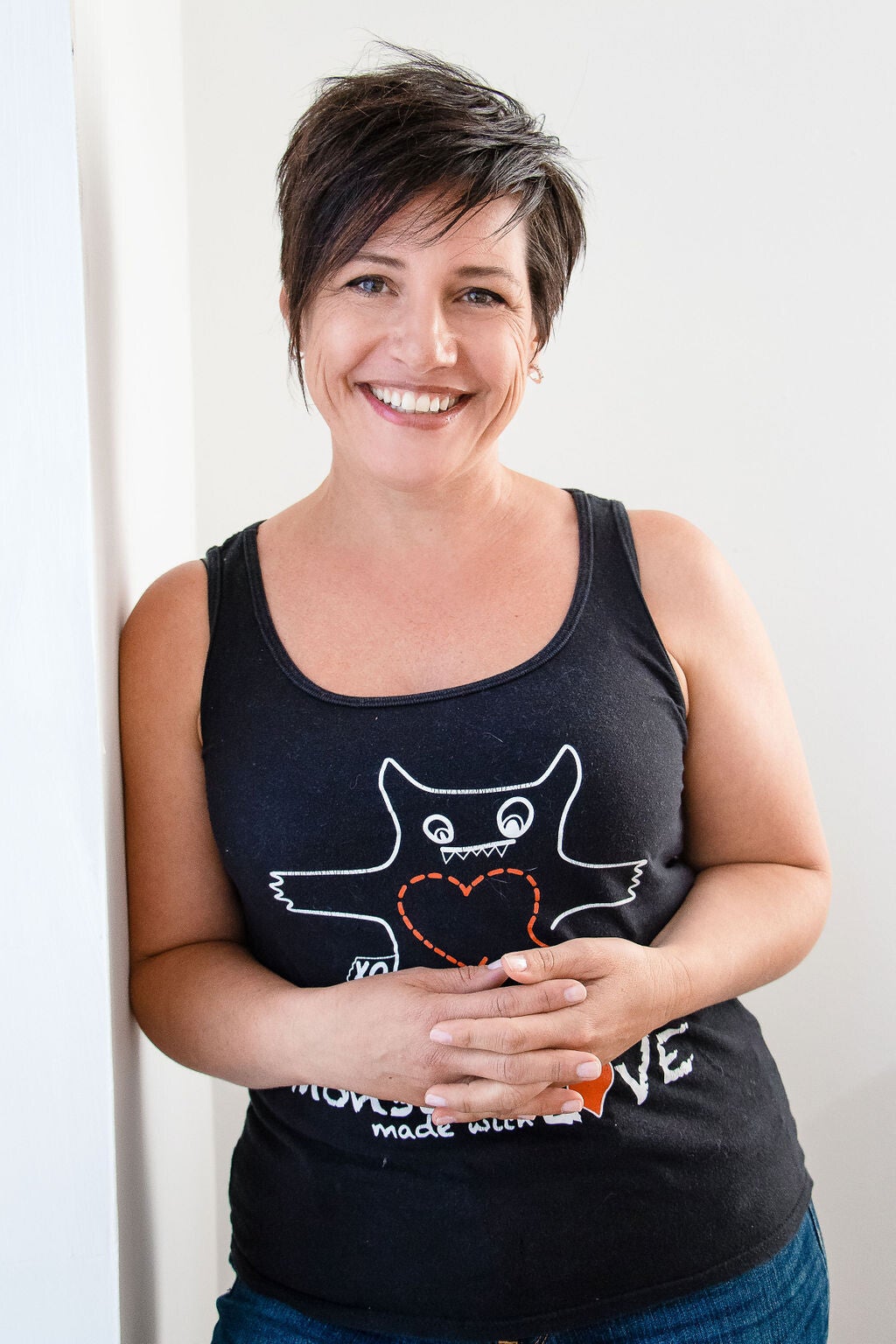 Laurie smiling while wearing a Monsters Made with Love shirt.