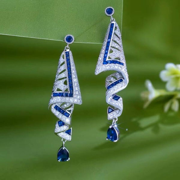 Blue crystal statement earrings with geometric detailing.