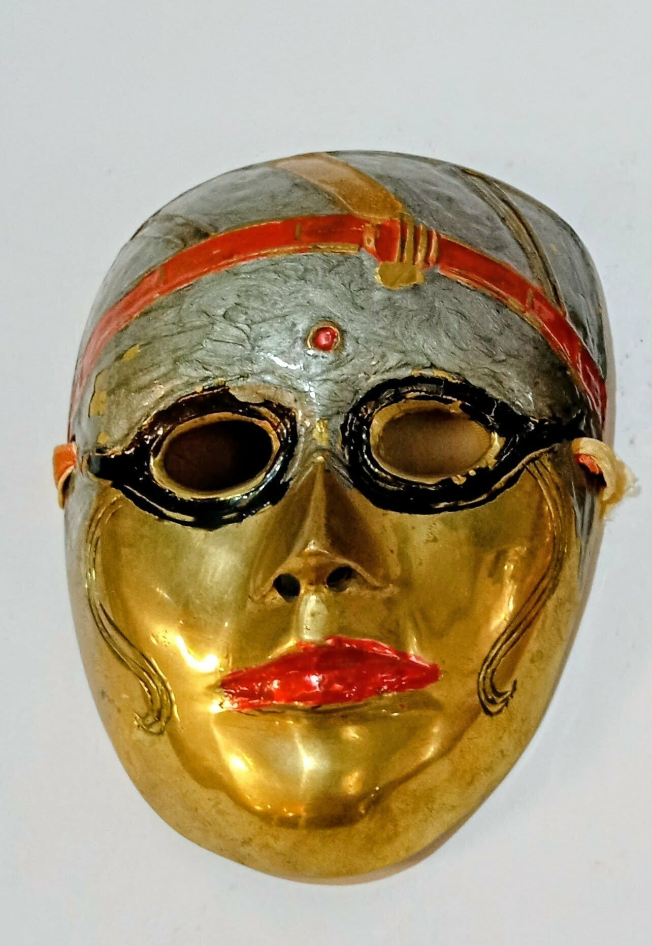 Pair of brass and enamelled face theatre masks