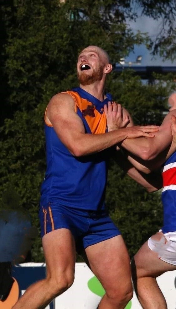 Sports players being watched by a sports trainer