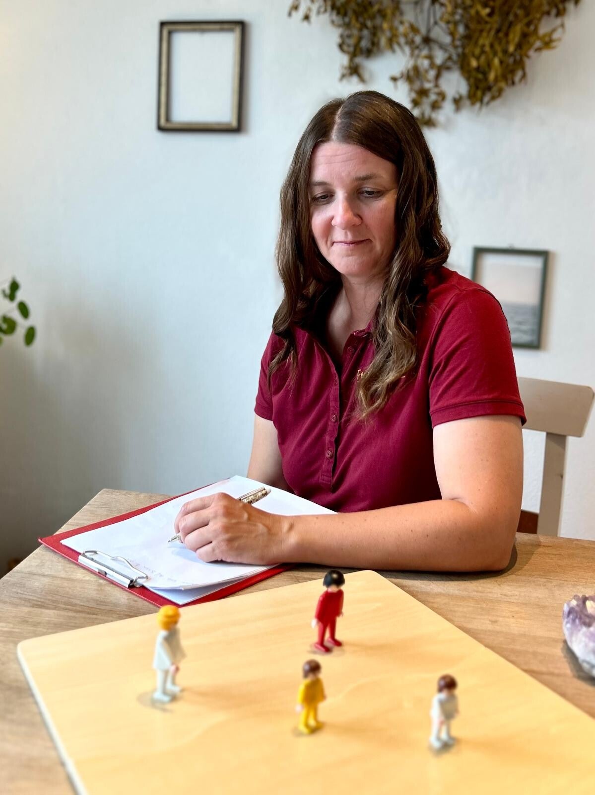 Zwei Frauen bei einer systemischen Aufstellung mit Figuren auf einem Systembrett.