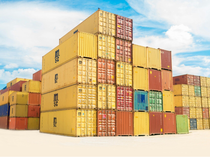 Stacked colorful shipping containers under a blue sky