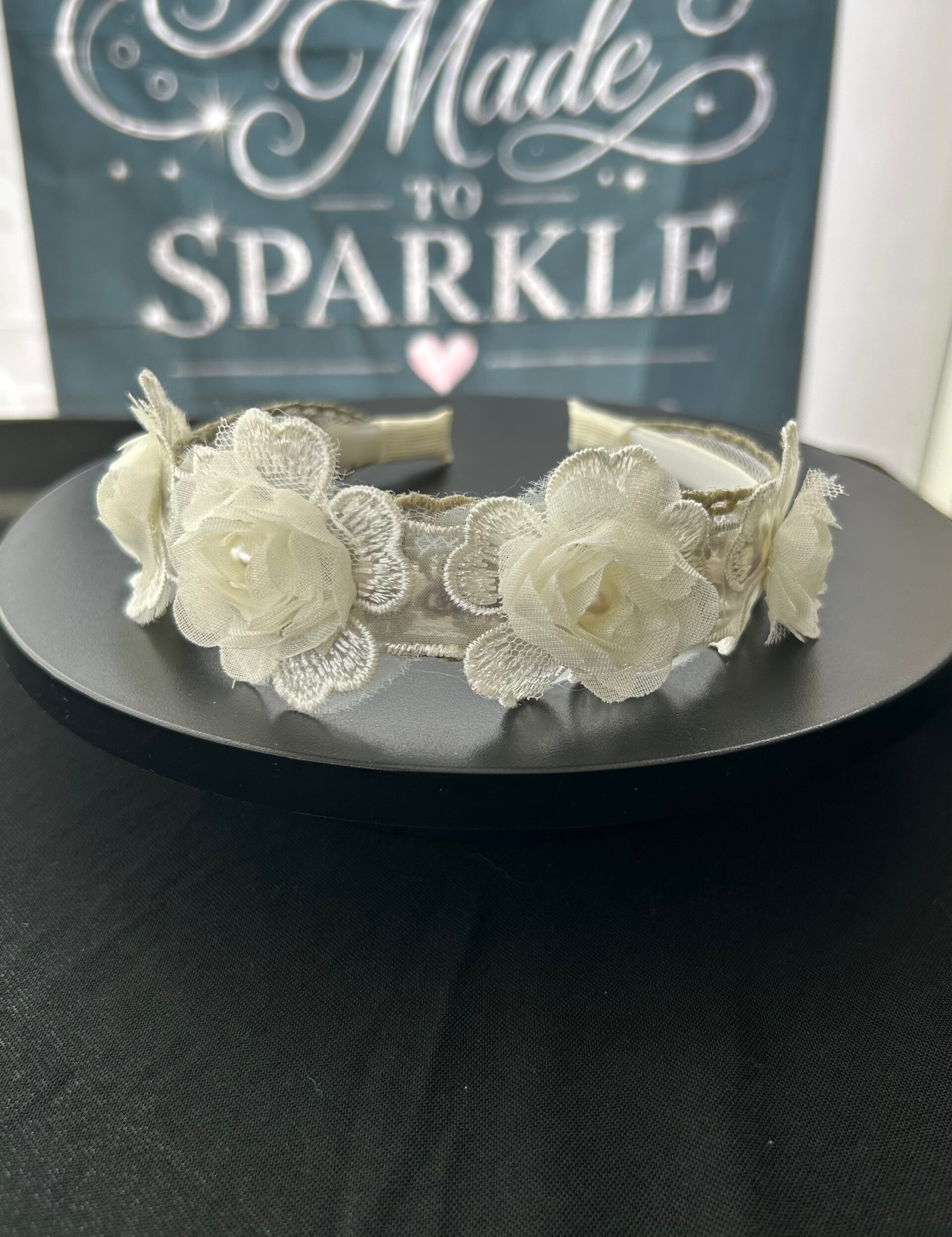 Green lace headband with flower embellishment