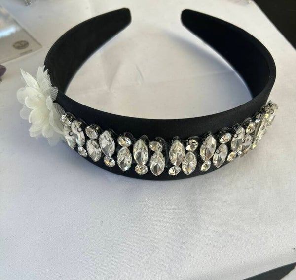 Black headband with silver trim and flower