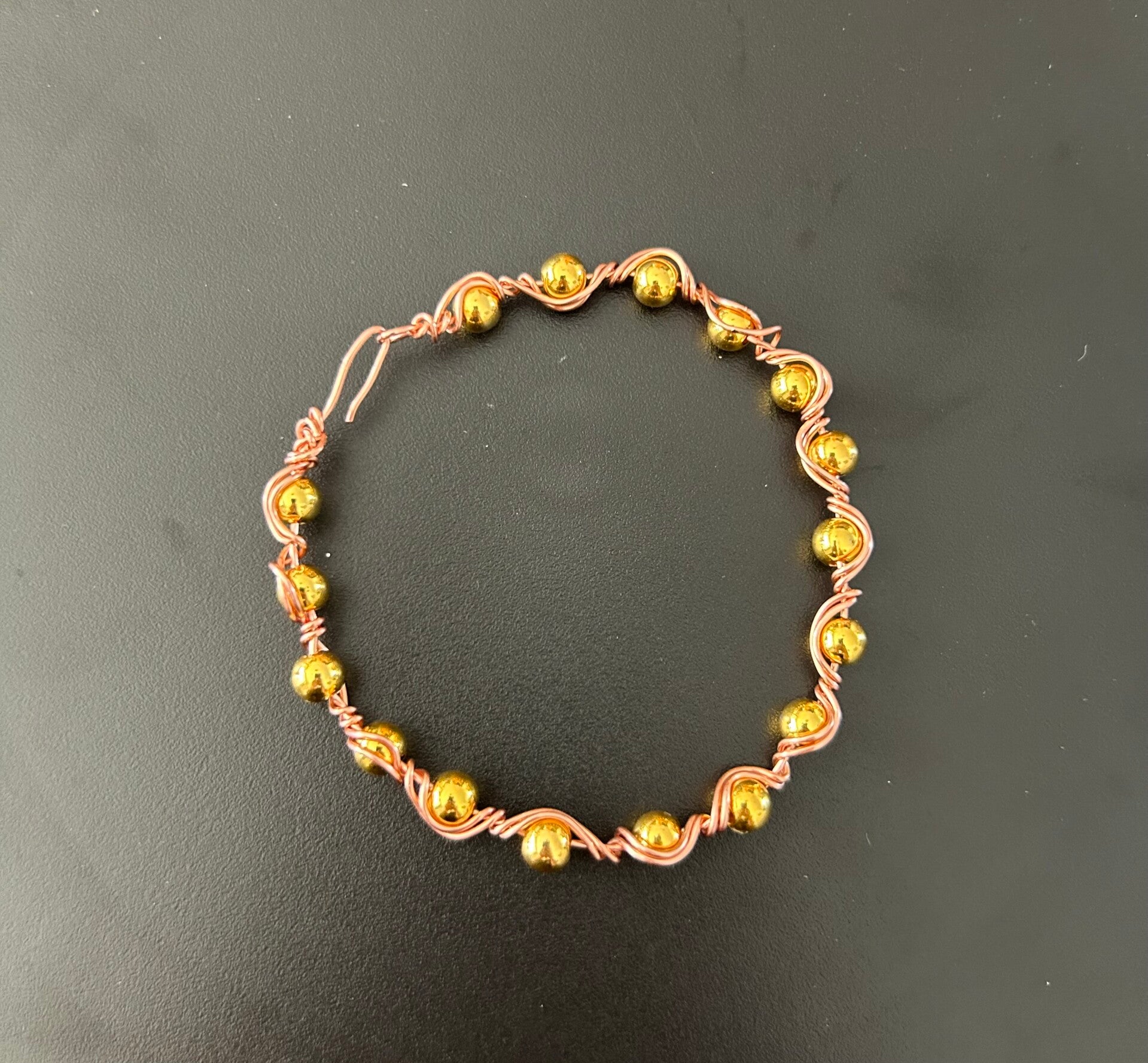 Copper bracelet with small gold beads