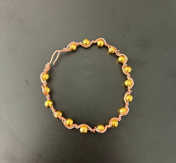 Copper bracelet with small gold beads