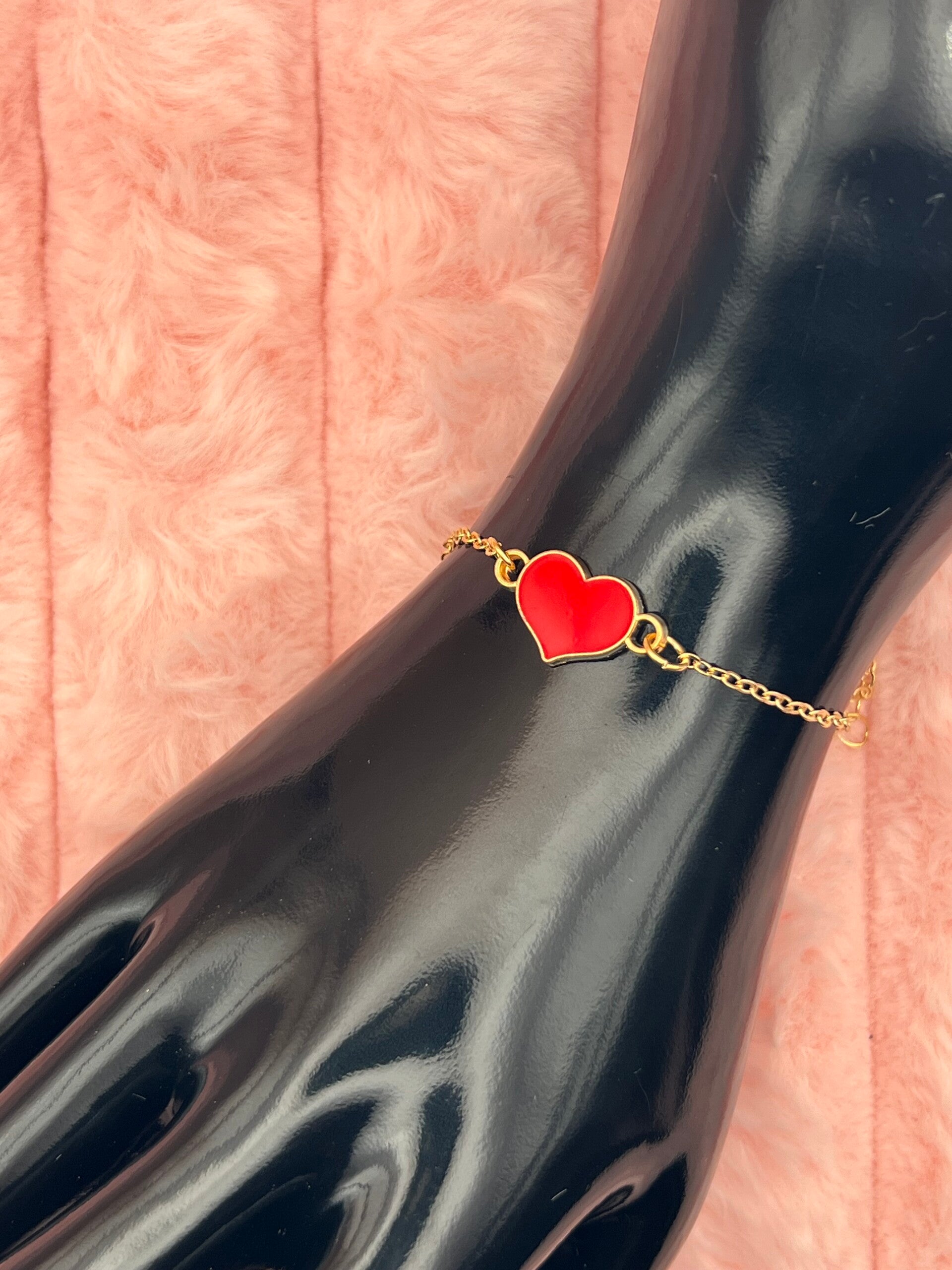 Goudkleurige armband met rood hartje