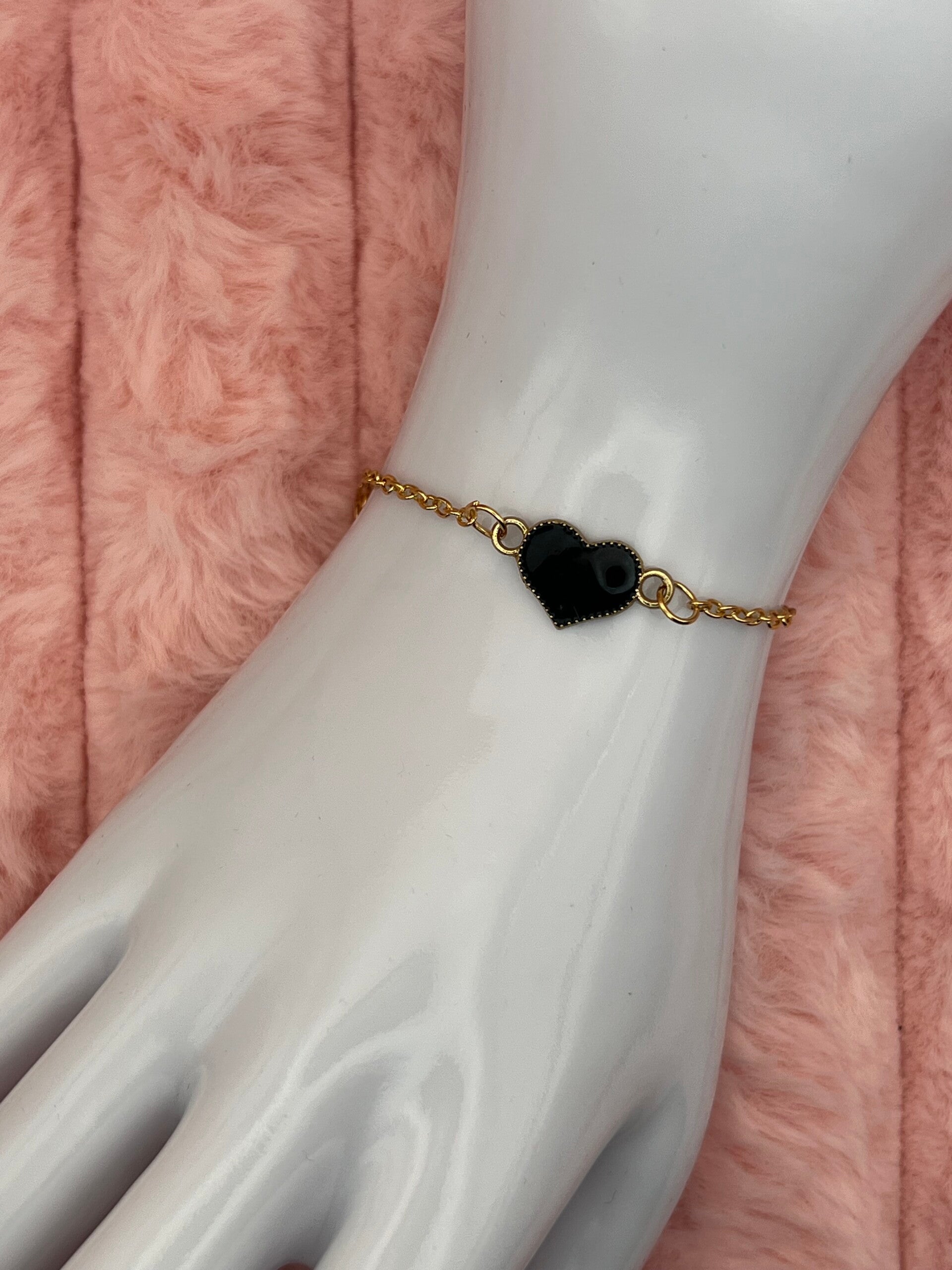 Goudkleurige armband met zwart hartje