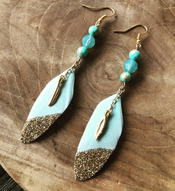 Gold dipped feather earrings light blue