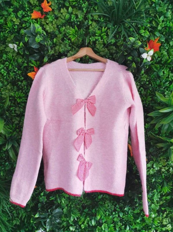 Pull rose noeuds papillon