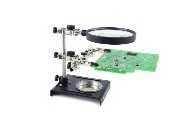 ATTEN FT-90A holding a circuit board in its clips beneath the magnifying lens