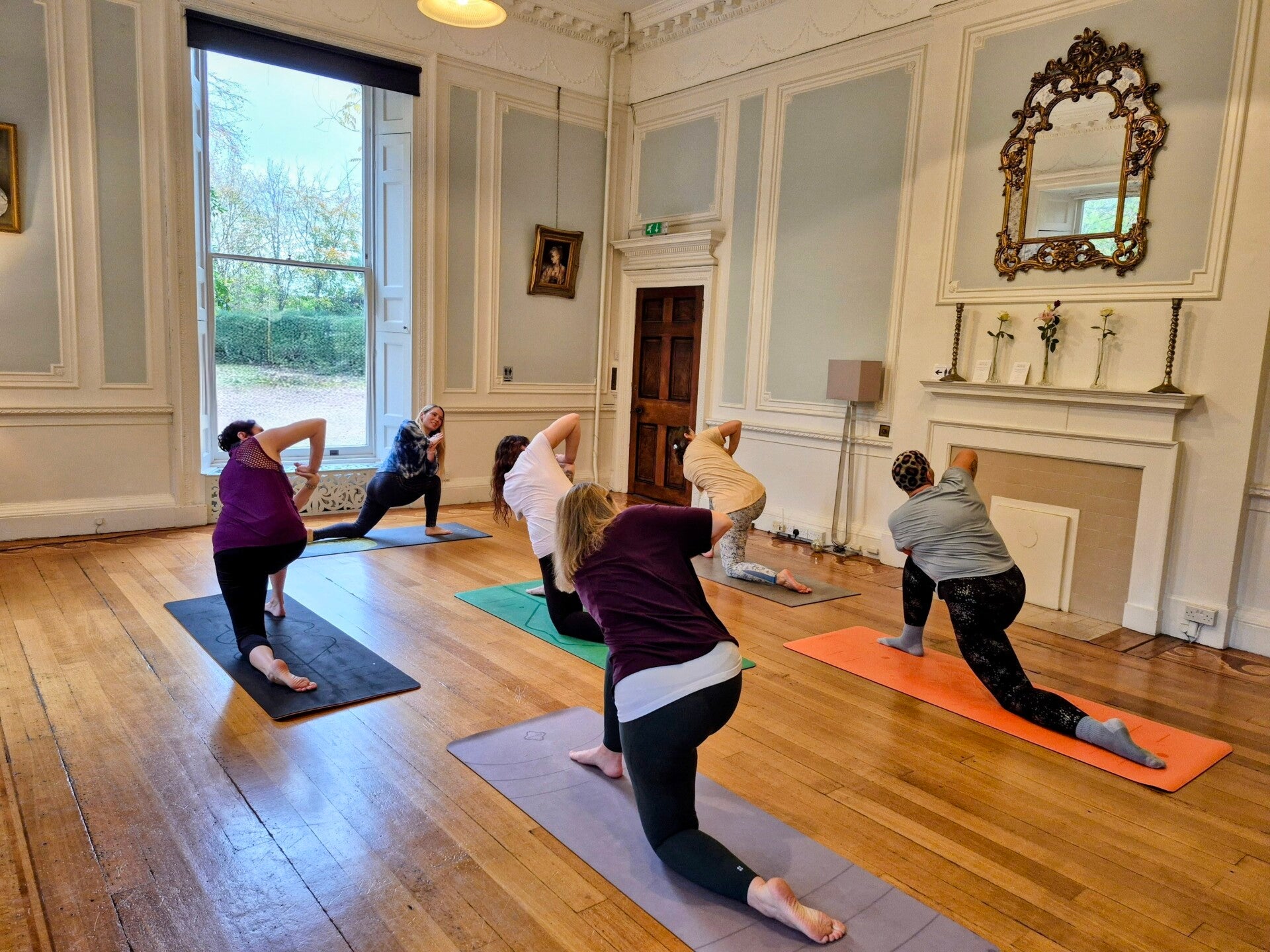 Yoga teacher instructing a yoga class