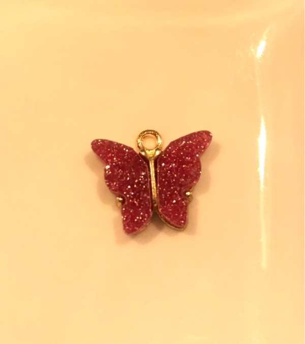 Vlinder bedel roze glitter