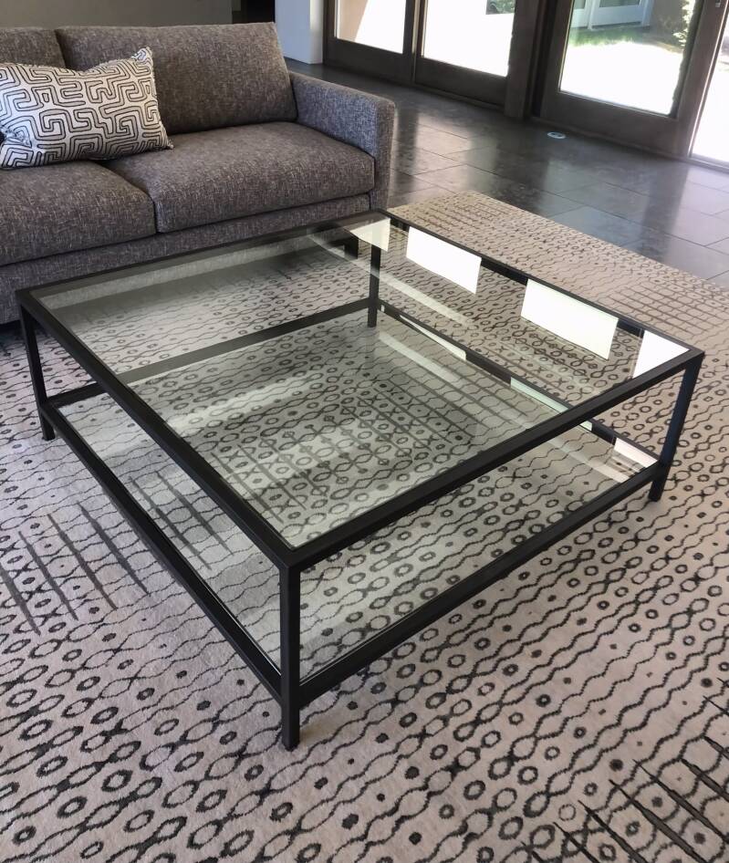 Steel table with glass top and shelf. 