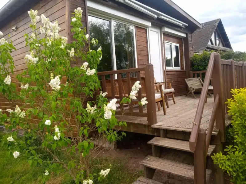 Terrasse en bois d’un gîte en Sologne avec salon de jardin, fleurs et espace extérieur au calme à Nouan-le-Fuzelier proche Lamotte-Beuvron