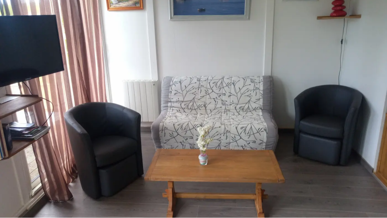 cozy living room area in a cottage in Sologne with sofa armchairs and coffee table France