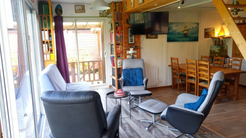 spacious living room of a family cottage in Sologne with seating area dining table and terrace access France