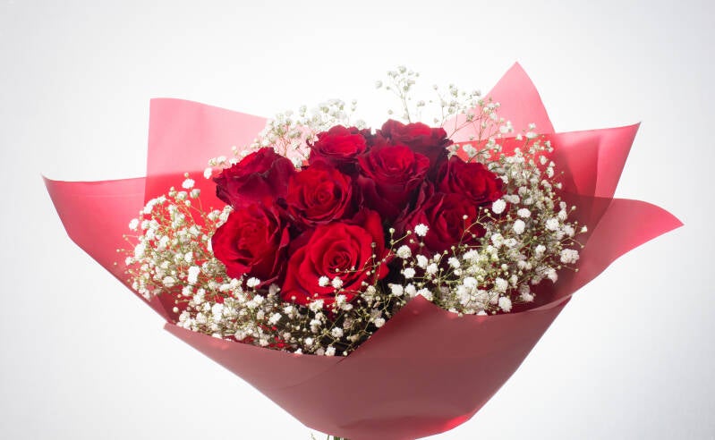 Bouquet of 15 red roses with greenery. Greenery may vary