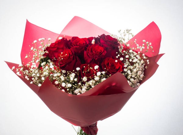 Bouquet of 7 red roses with greenery
