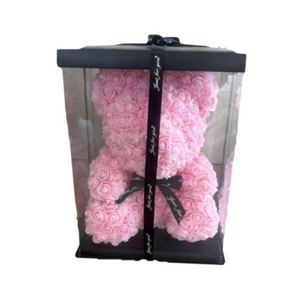Pink teddy bear in the box.