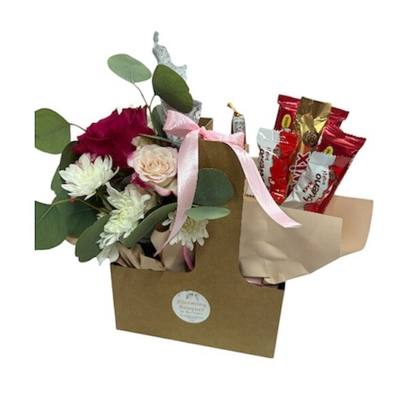 Flowers and chocolates in a paper bag ( flowers and chocolates may vary)