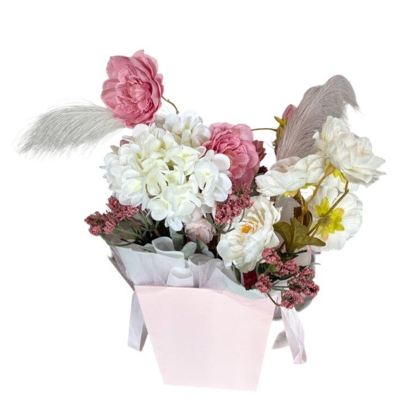Paper box with artificial white and pink flowers