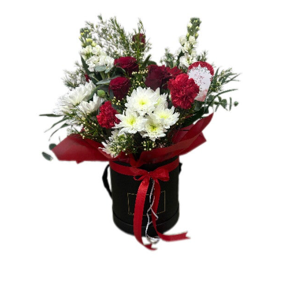 Various red and white flowers in the box with greenery