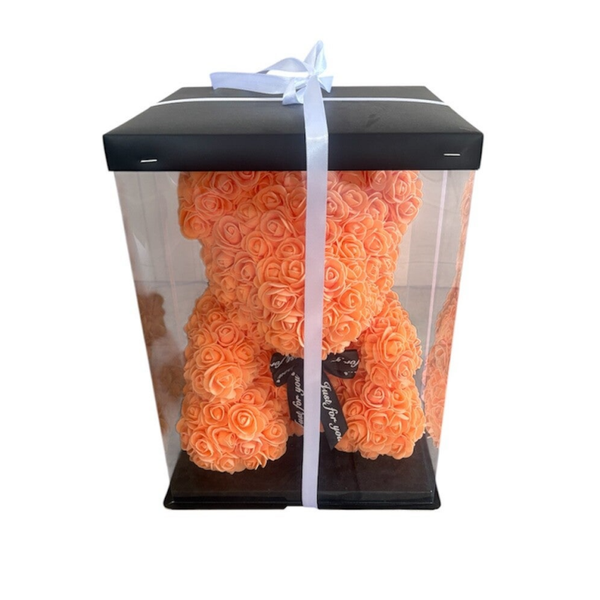 Orange teddy bear in the box.