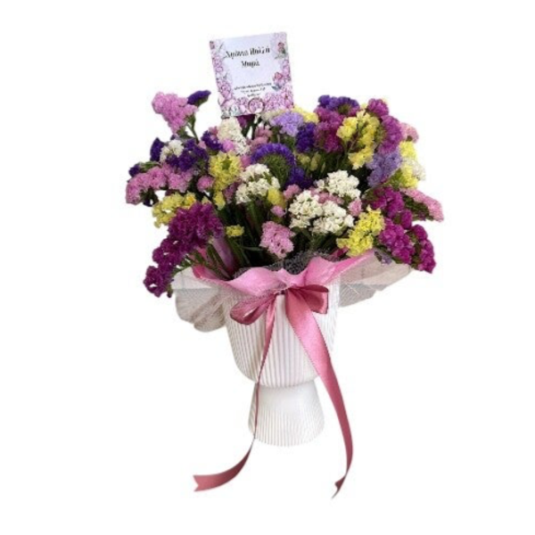 Statice flowers in a white cup