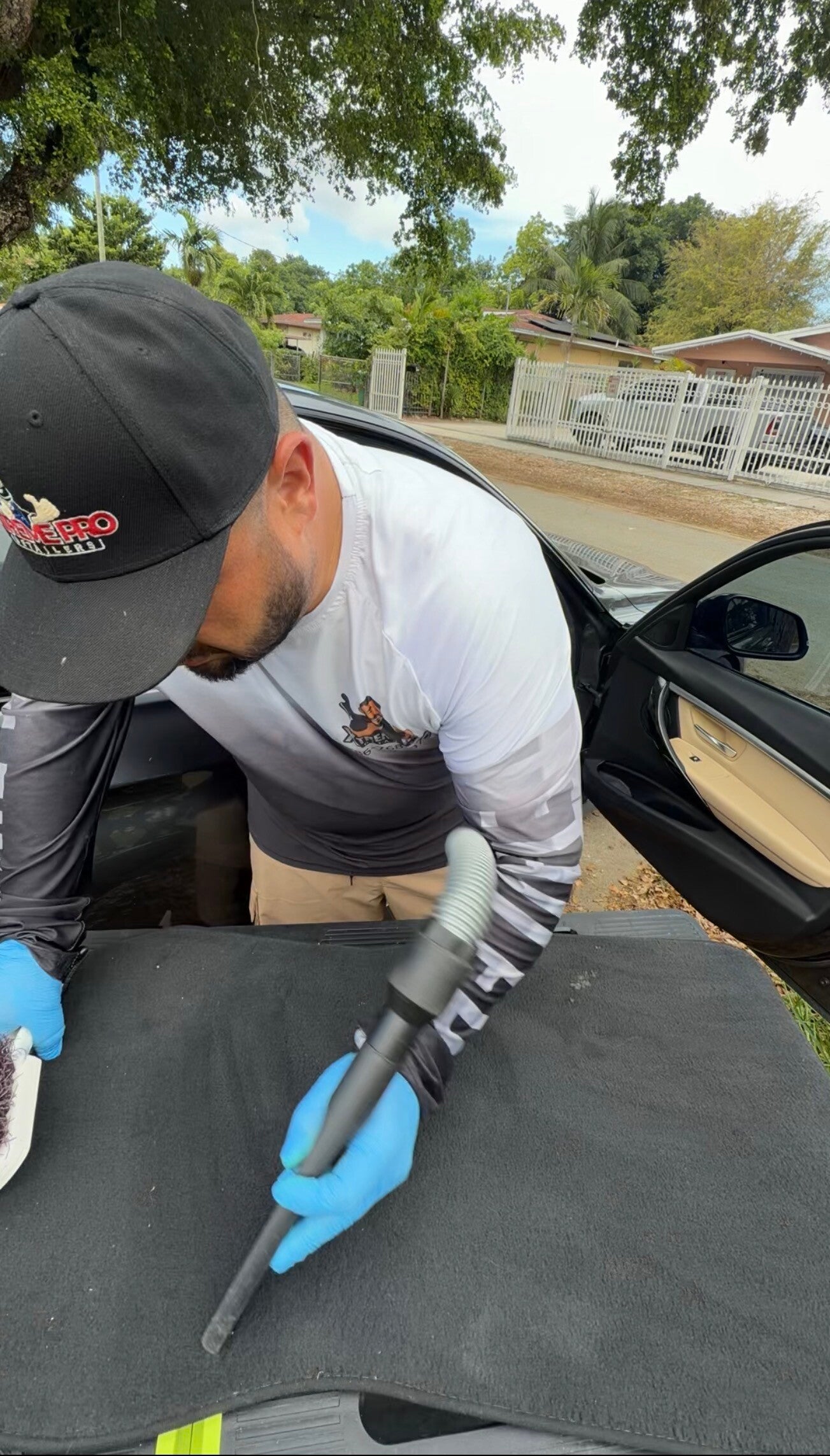 Xtreme Pro Detailers vacuuming a vehicle interior during a mobile car detailing service in Miami