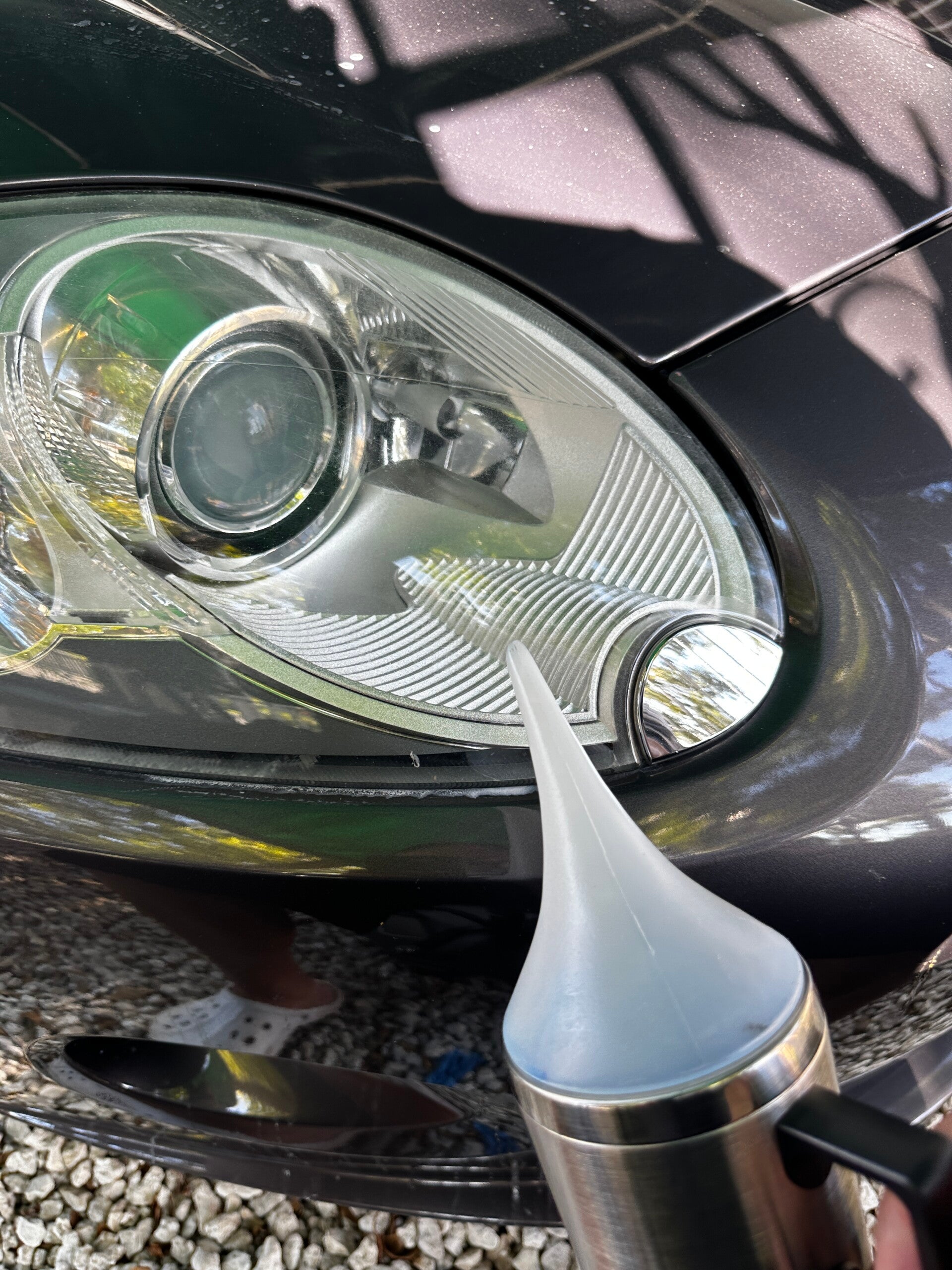 Xtreme Pro Detailers restoring a cloudy vehicle headlight to improve clarity, brightness, and appearance in Miami
