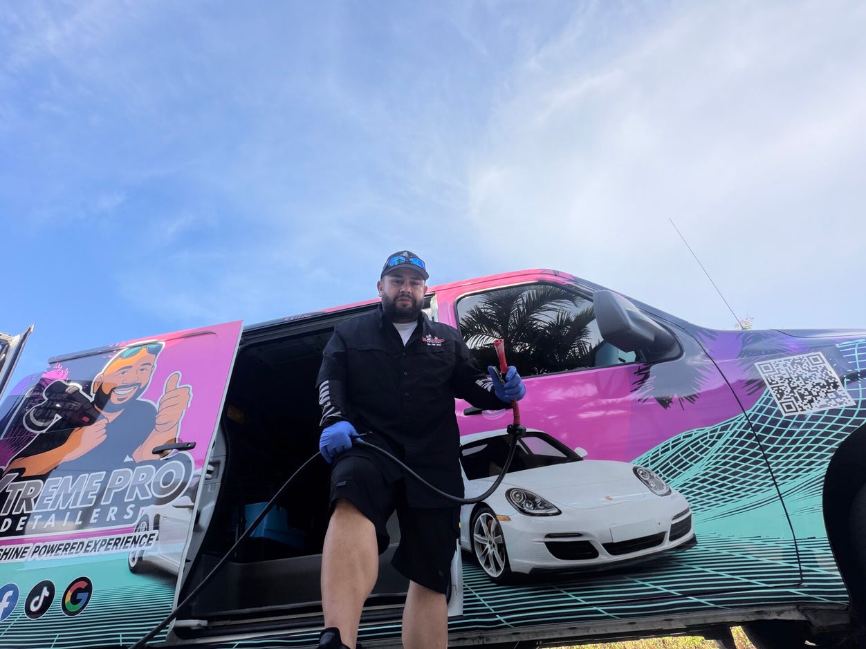 Xtreme Pro Detailers owner with branded service van in Miami