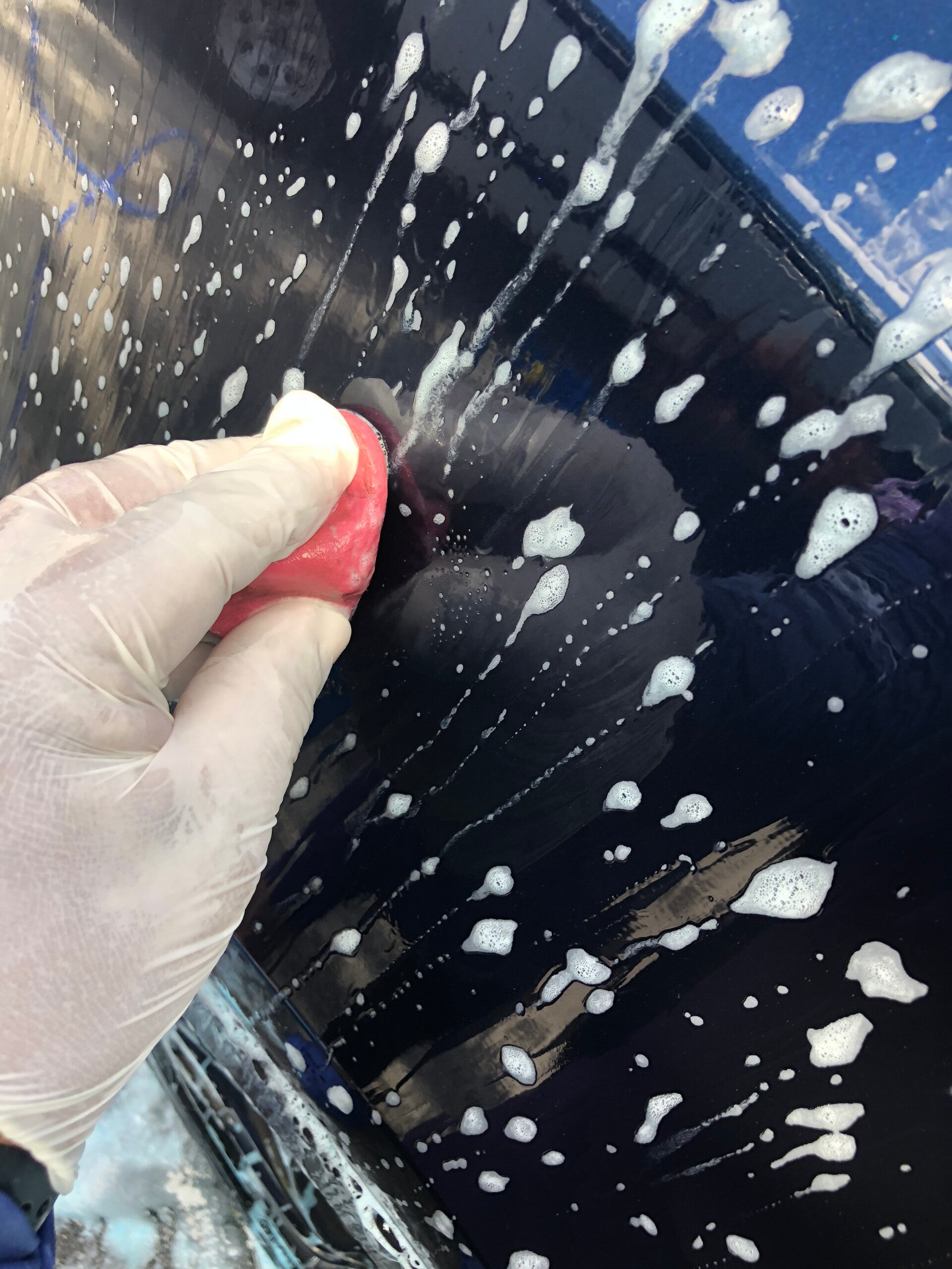 Xtreme Pro Detailers performing a professional clay bar treatment to remove bonded paint contaminants in Miami