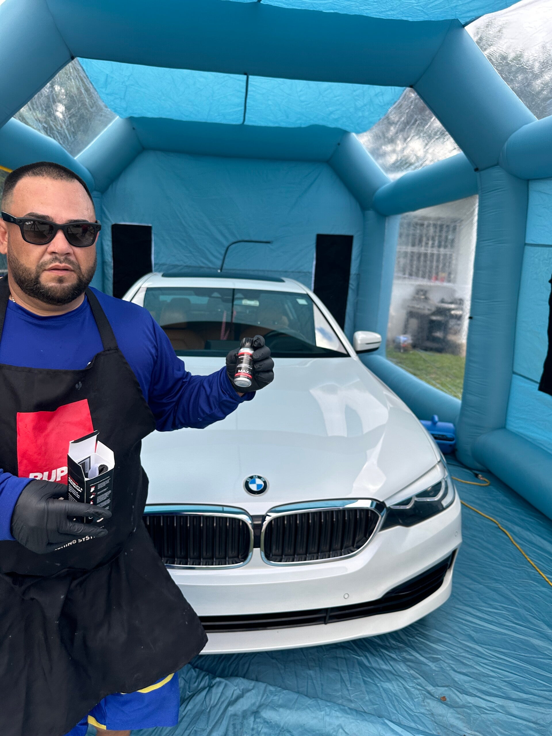 Owner of Xtreme Pro Detailers showcasing a white BMW after professional ceramic coating application in Miami